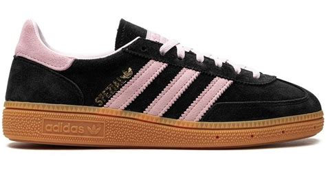 pink and black adidas sneakers.